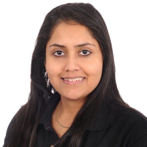 Vidhi smiling warmly, part of the Synergy Rehab rehabilitation and wellness team in British Columbia.