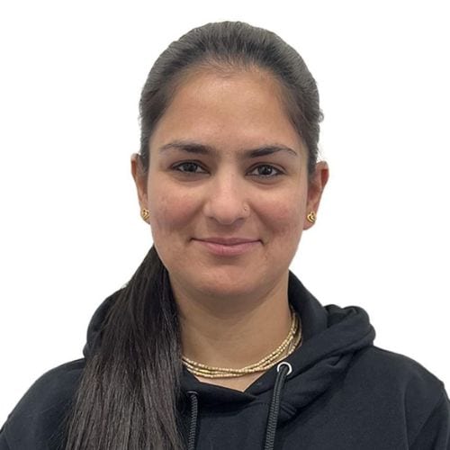 Professional headshot of Navjeet Bhardwaj, Physiotherapist at Synergy Rehab, wearing a black hoodie.