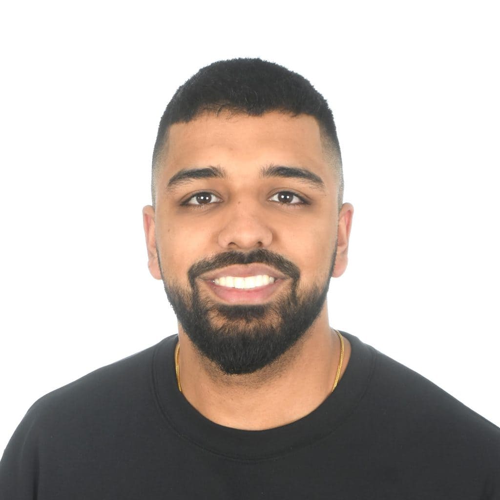 Jatan Brar smiling warmly in a dark top, part of the Synergy Rehab physiotherapy and active rehabilitation team.
