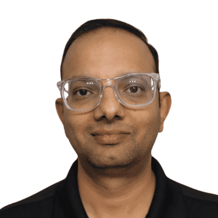 Manish Kumar wearing glasses at Synergy Rehabilitation clinic.
